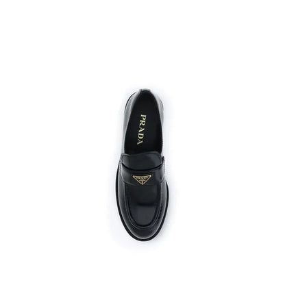 Black leather loafer with gold Prada logo detail, luxury designer footwear