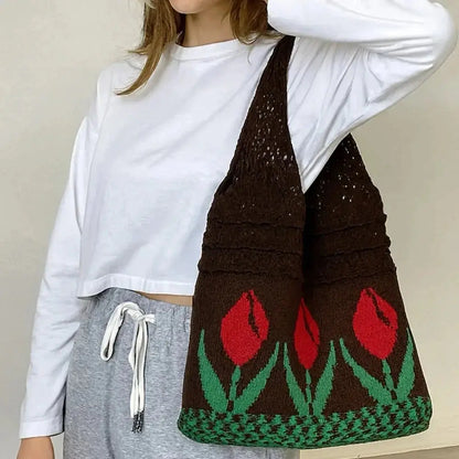 Brown crochet tote bag with red tulip flower design, worn over the shoulder