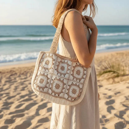 Woman at the beach carrying a handmade crochet cotton tote bag with boho design