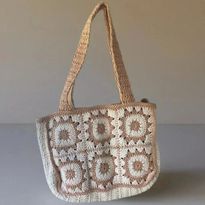 Handmade crochet tote bag with beige and cream cotton yarn in boho style on plain background