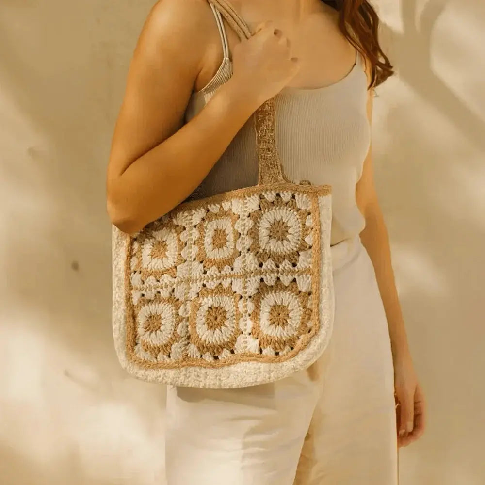 Handmade crochet tote bag in beige and white cotton yarn with boho pattern on shoulder