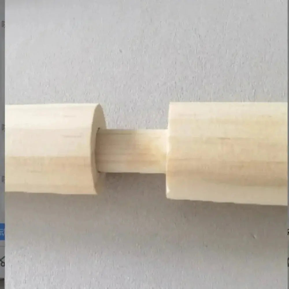 Close-up of wooden dowel parts joined together on a neutral background, macrame hardware