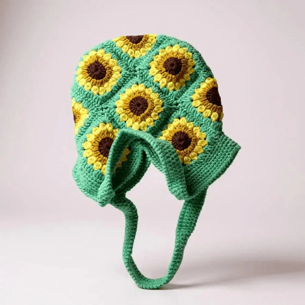 Handmade crochet bag with sunflower pattern, green base, yellow and brown accents