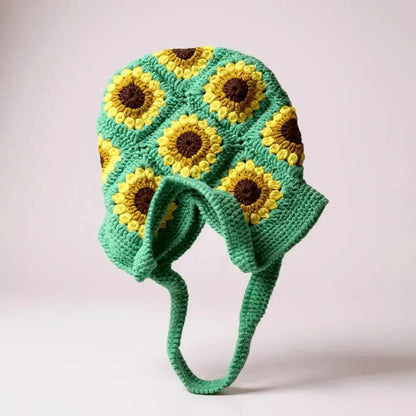 Handmade crochet bag with sunflower pattern, green base, yellow and brown accents