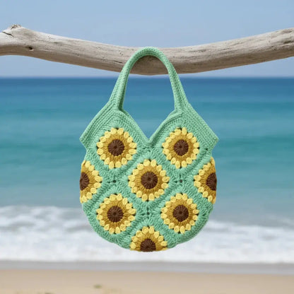 Handmade sunflower crochet cotton bag with boho design hanging by the beach