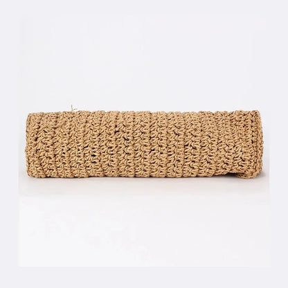 Bottom view of woven raffia tote bag with twisted texture against white background