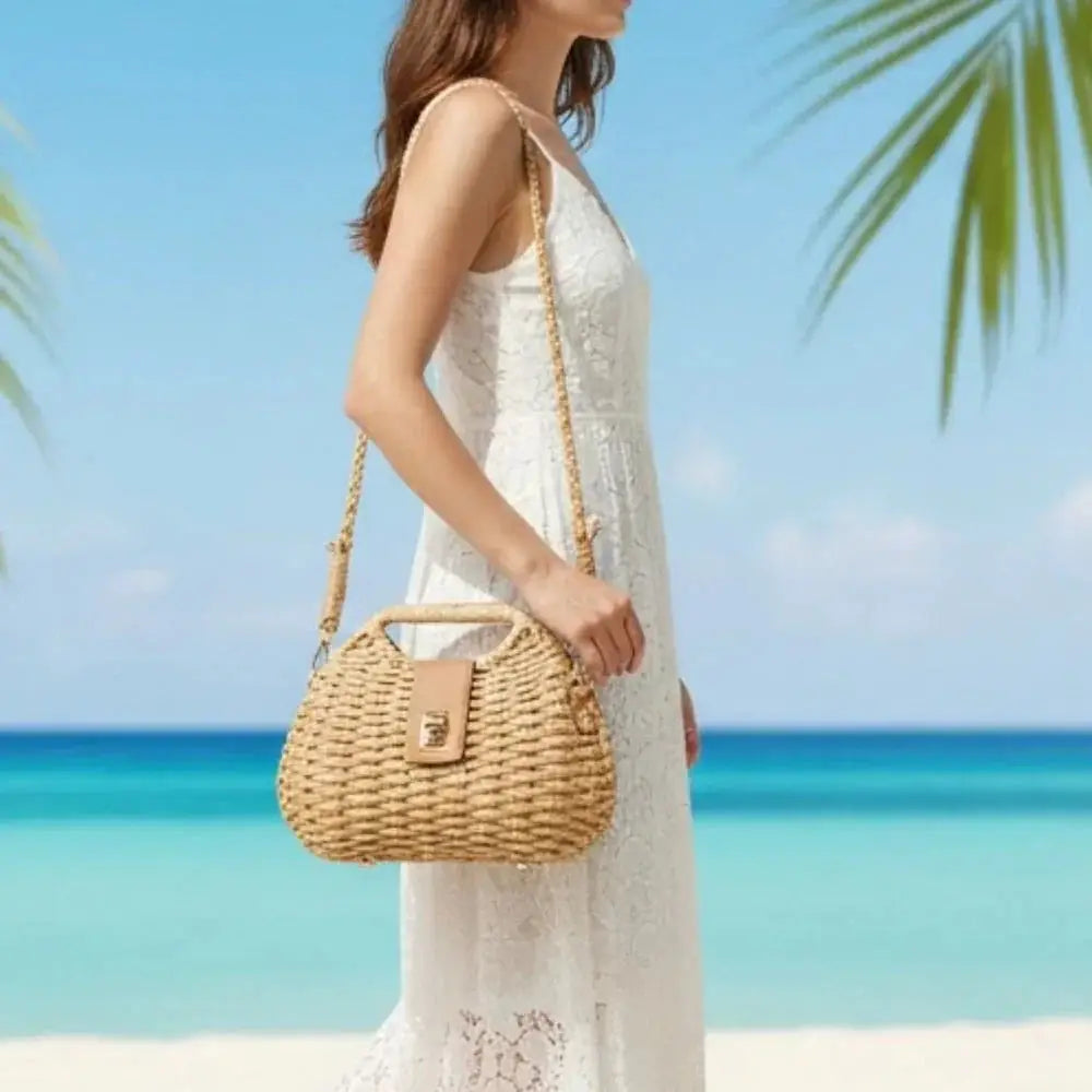 Woman in white lace dress holding woven straw crossbody bag on tropical beach