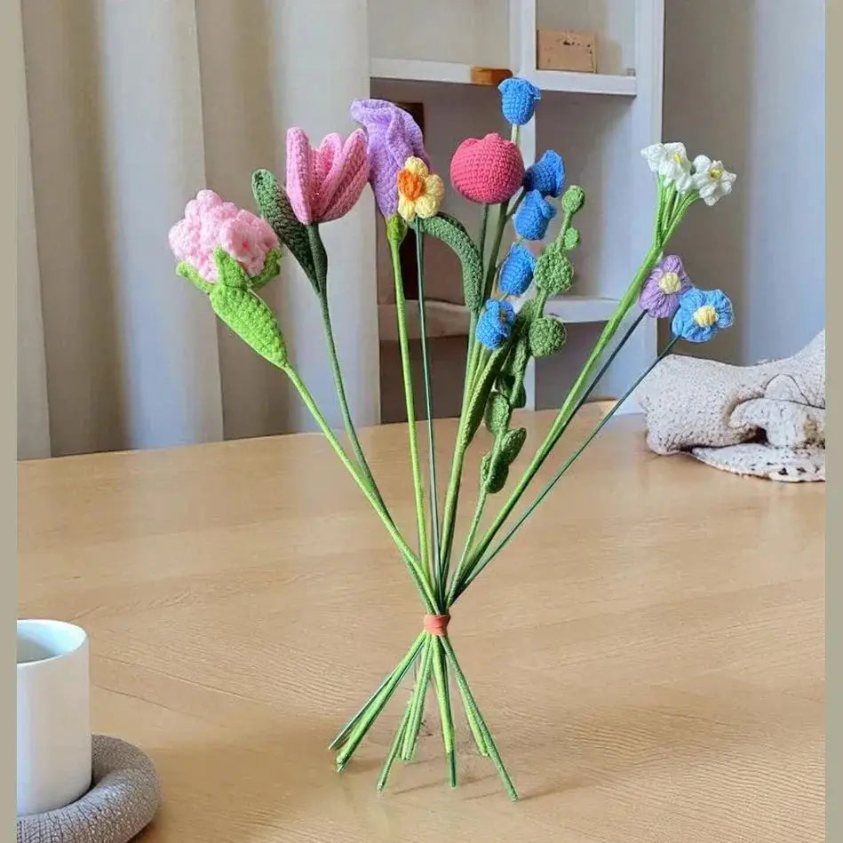 Colorful handmade crochet flower bouquet on a wooden table, home decor accent.